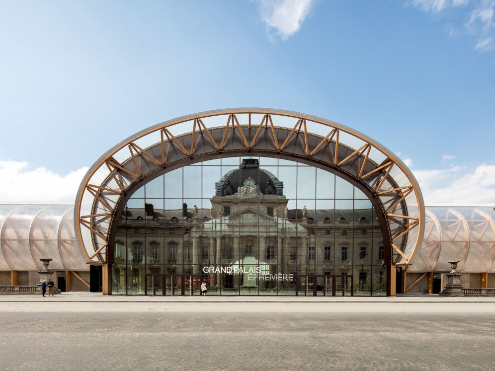 The Grand Palais Éphémère in Paris, its timber arch framing the facade behind the glass